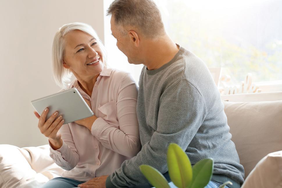 Free Image of Senior couple relax at home in casual clothes, smiling. 