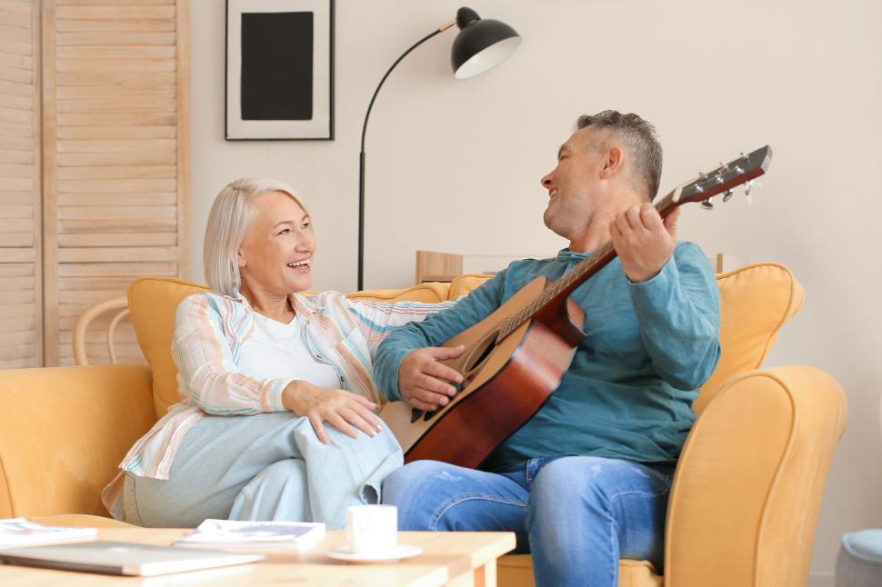 Free Image of Elderly couple enjoying a music session at home 