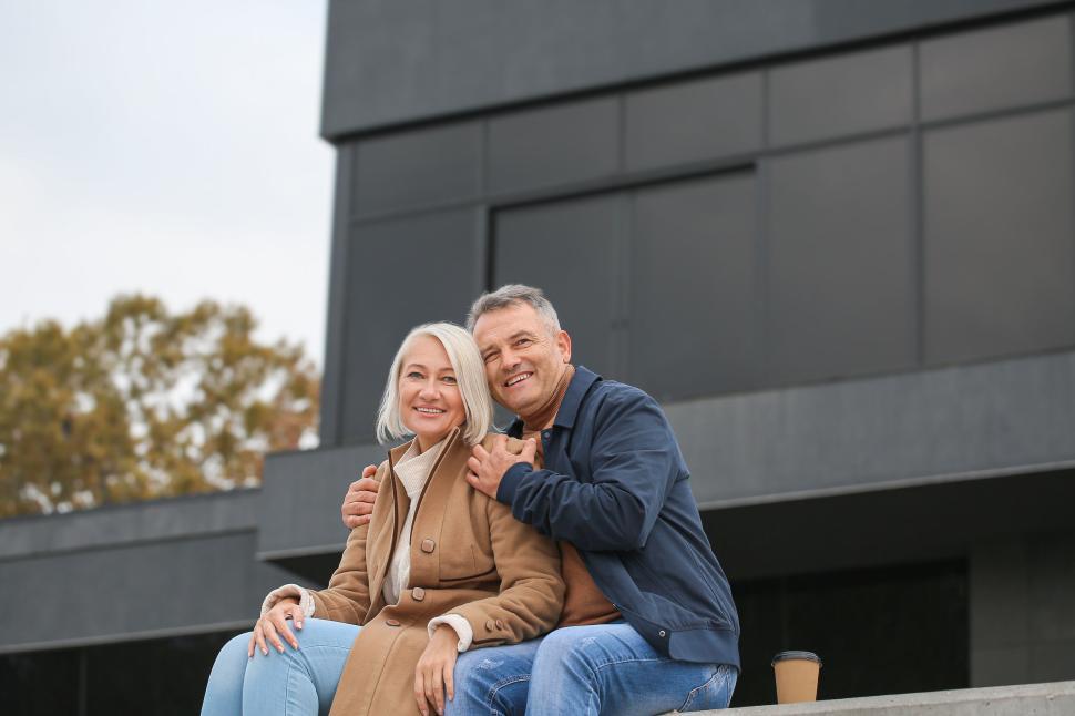 Free Image of Happy couple enjoying outdoor coffee together 