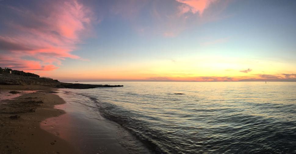 Free Image of Calm evening sea with colorful sunset sky 