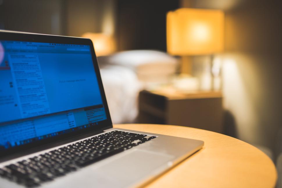 laptop-on-a-wooden-table-in-a-cozy-well-lit-room..jpg