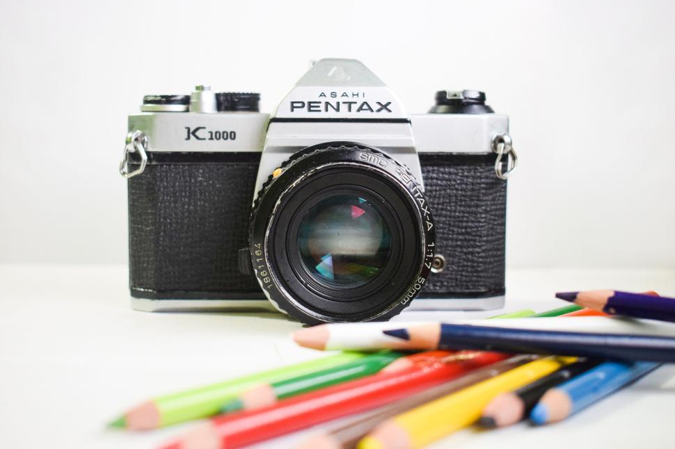 Free Image of Close-up of a vintage Pentax K1000 camera with pencils 