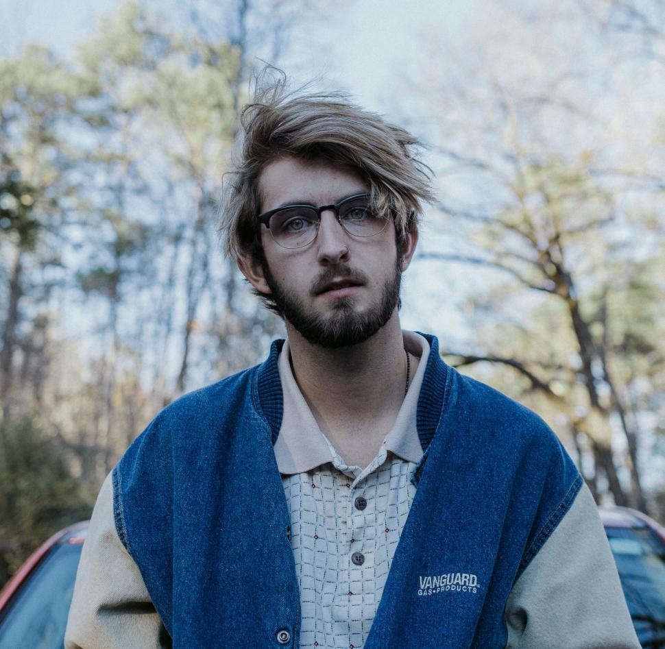 Free Image of Bearded young man with glasses outdoors in casual jacket. 