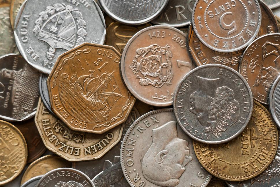Free Image of Various foreign coins in a scattered arrangement close-up. 