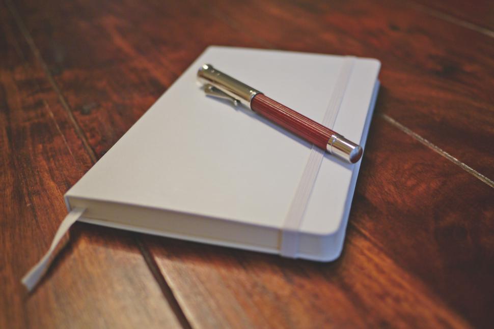Free Image of Notebook with pen on wooden table, ready for writing 