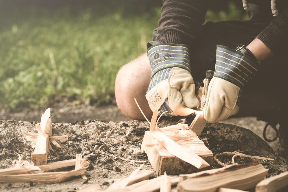 Free Image of Person carving wood with gloves, rustic and focused 