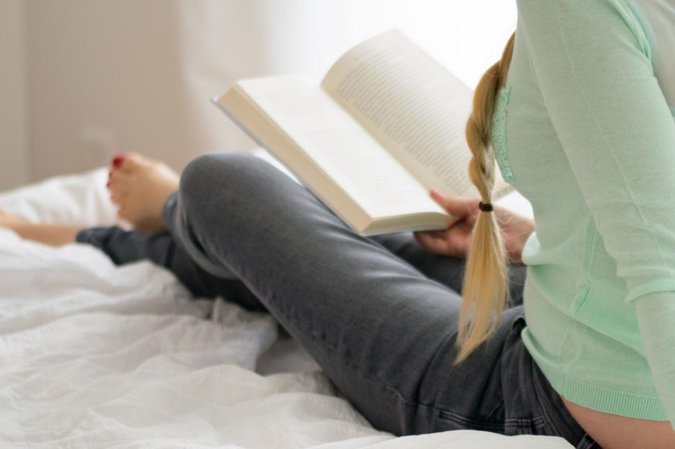 Free Stock Photo of Person on bed reading a book with focus on the book. |  Download Free Images and Free Illustrations