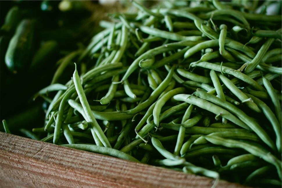 Free Image of Close-up of fresh green beans in a wooden container 