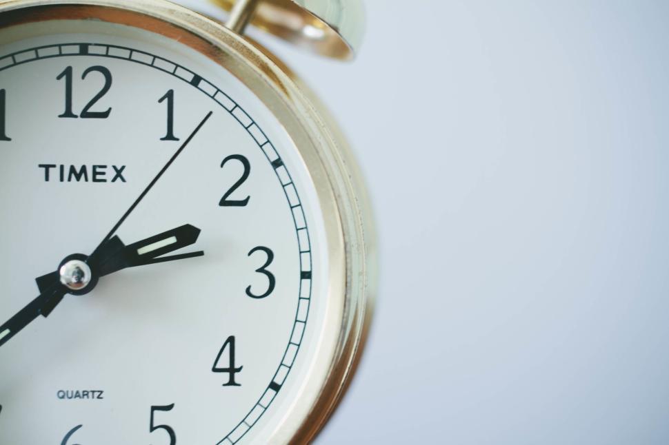 Free Image of Close-up of Timex white face clock showing 505 