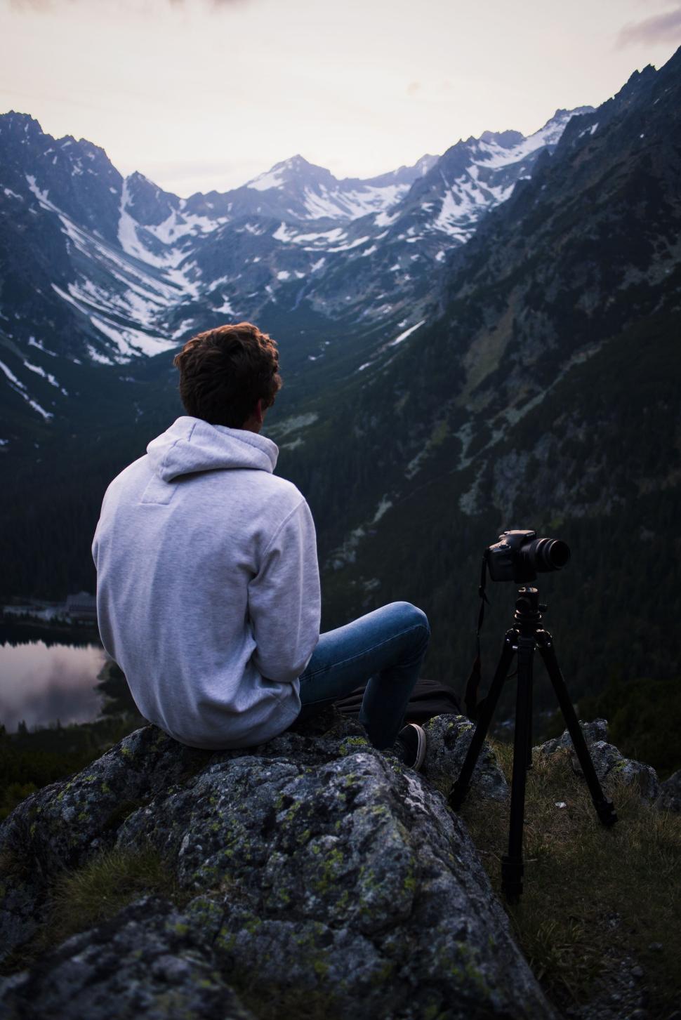 Free Image of Person overlooking scenic mountain landscape with camera. 