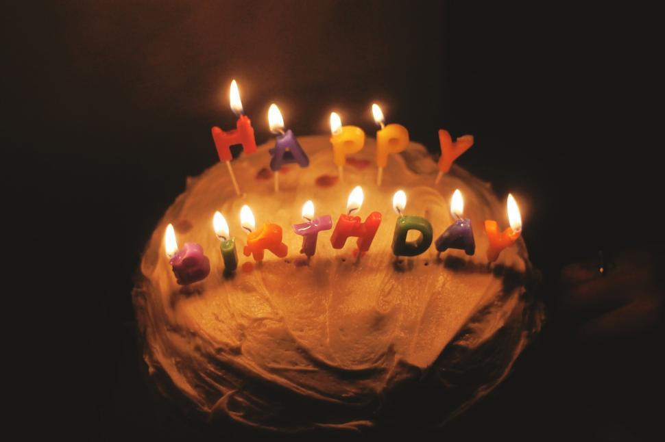 Free Image of Close-up shot of a lit birthday cake with candles aglow 