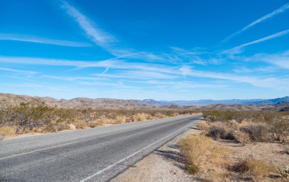 Free Image of Desert Road Stretching to the Horizons and Mountains 