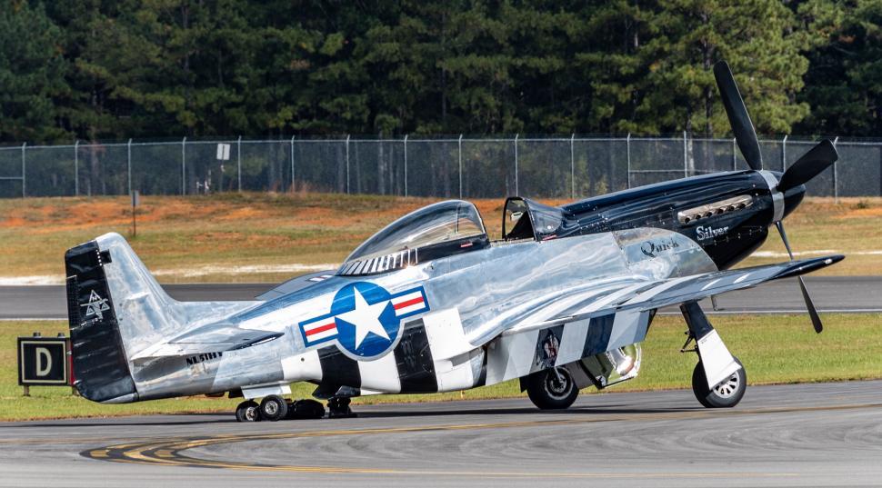 Free Image of Vintage aircraft parked on runway with pilot inside 