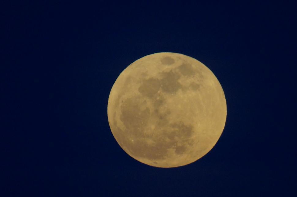 Free Image of Full Moon glowing in pitch-black night sky 
