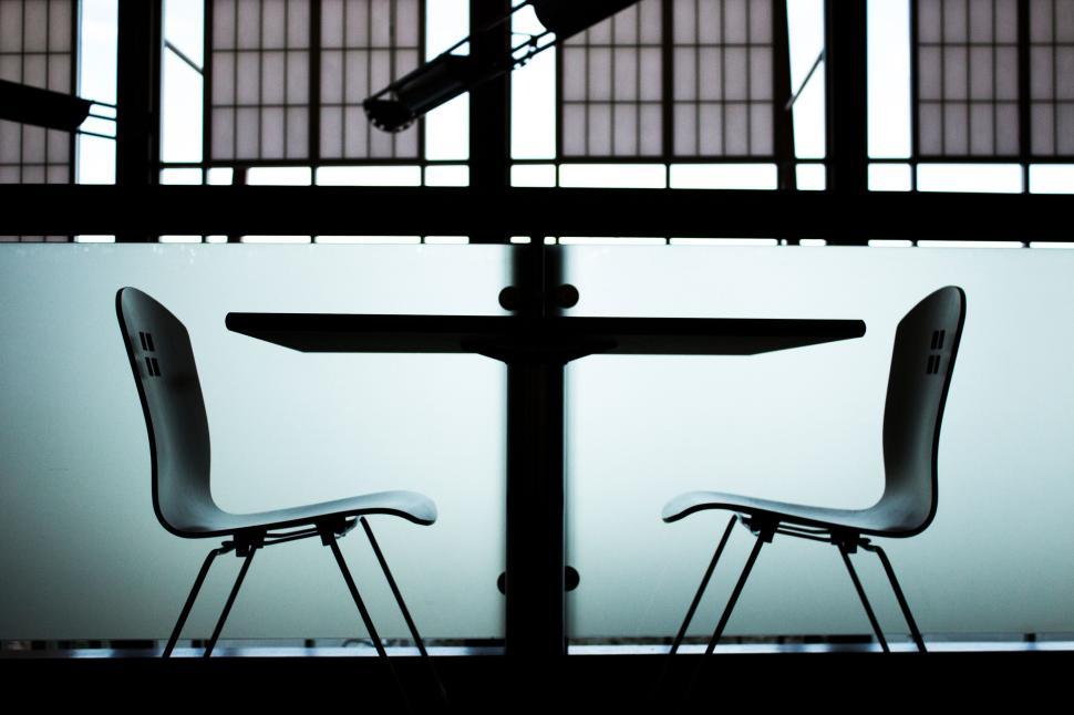 Free Image of Silhouette of chairs and table in modern setting 