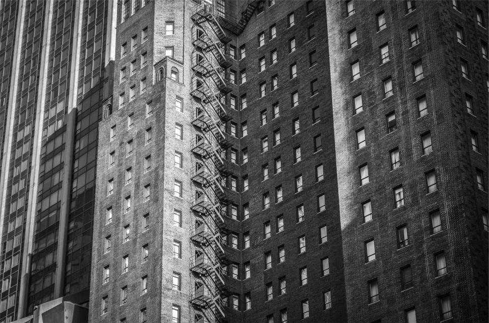 Free Image of Gray-scale photo of large high-rise buildings with windows 