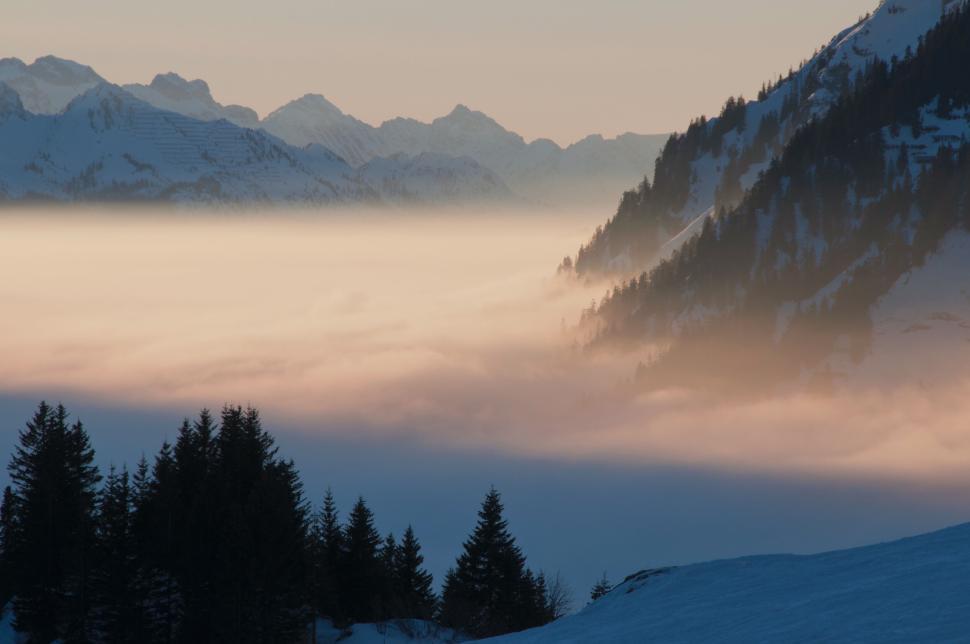 Free Image of Mountain valley with fog during beautiful sunrise scenery 
