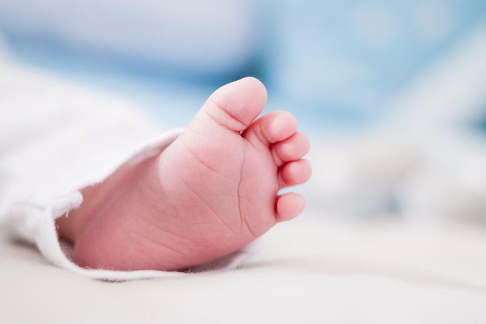 Free Image of Close-up of a baby foot wrapped in a soft fabric. 