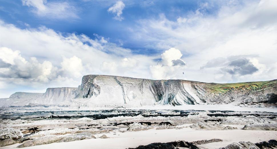 Free Image of Rocky landscape with a blue cloudy sky in background 