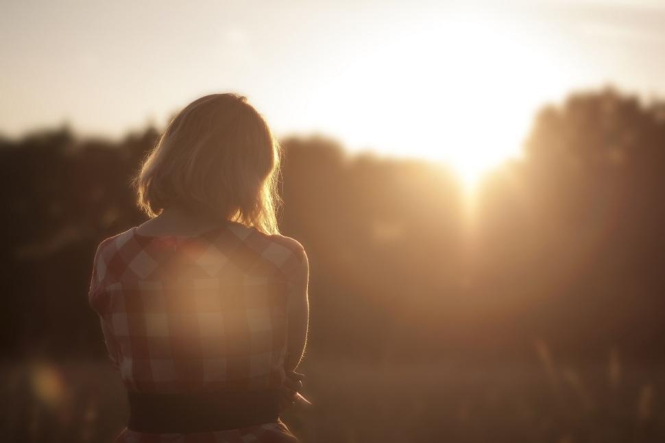 Free Image of Person in the sunset standing alone in field view 