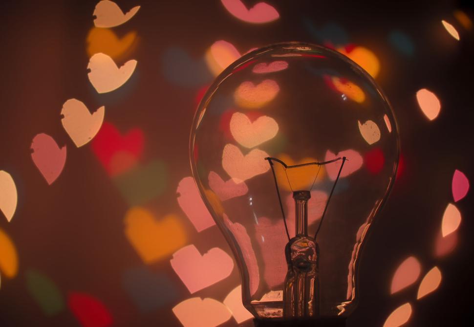 Free Image of Light bulb with heart-shaped bokeh background. 