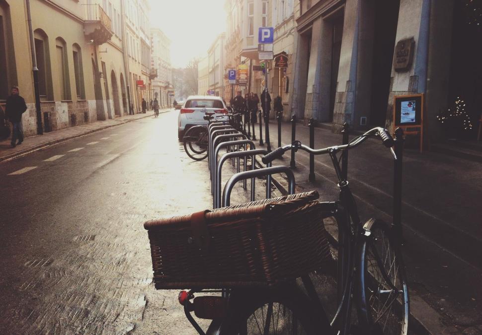 Free Image of Bike with a basket parked on a quaint city street 