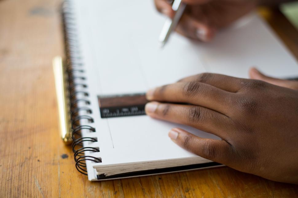 Free Image of Close-up of a hand drawing with a ruler and pen 