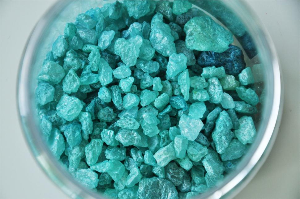 Free Image of Close-up of aqua blue crystals in clear container. 