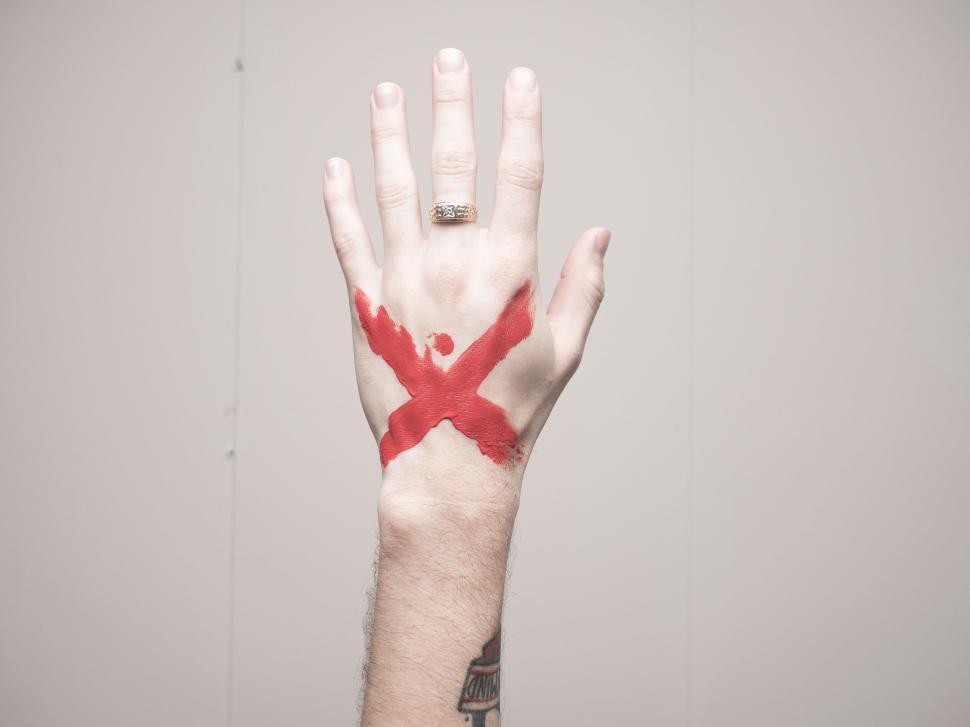 Free Image of Hand with red X painted as a symbol against injustice 