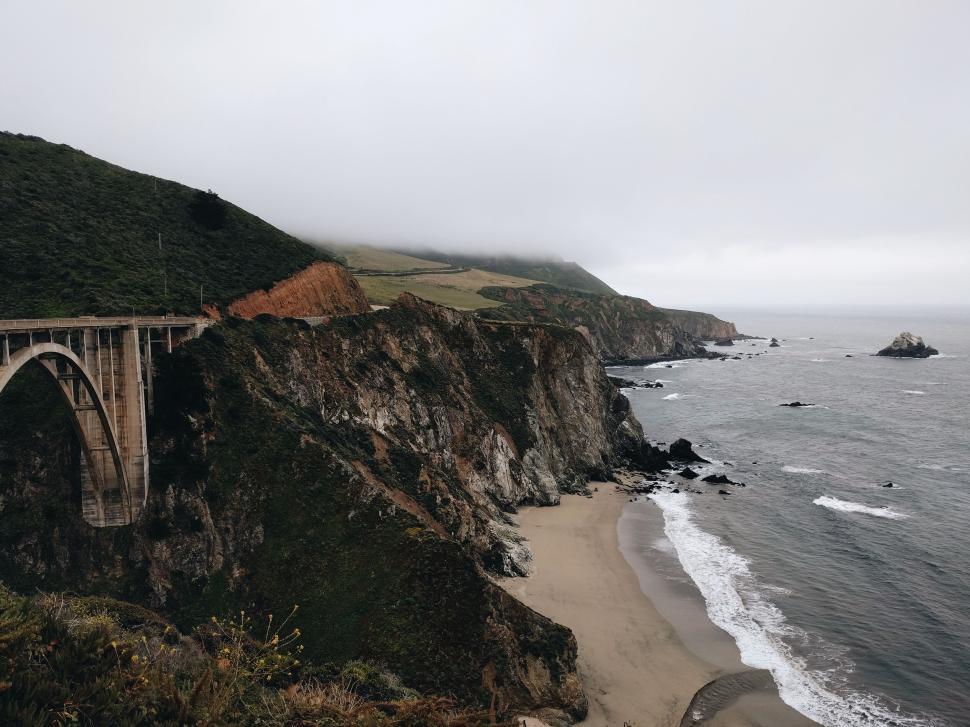 Free Image of Foggy coastal landscape with historic bridge on cliffs 