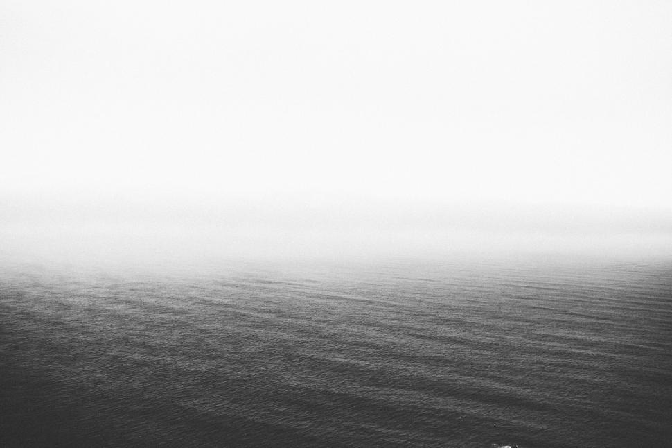Free Image of Minimalist ocean view under foggy sky with calm water 