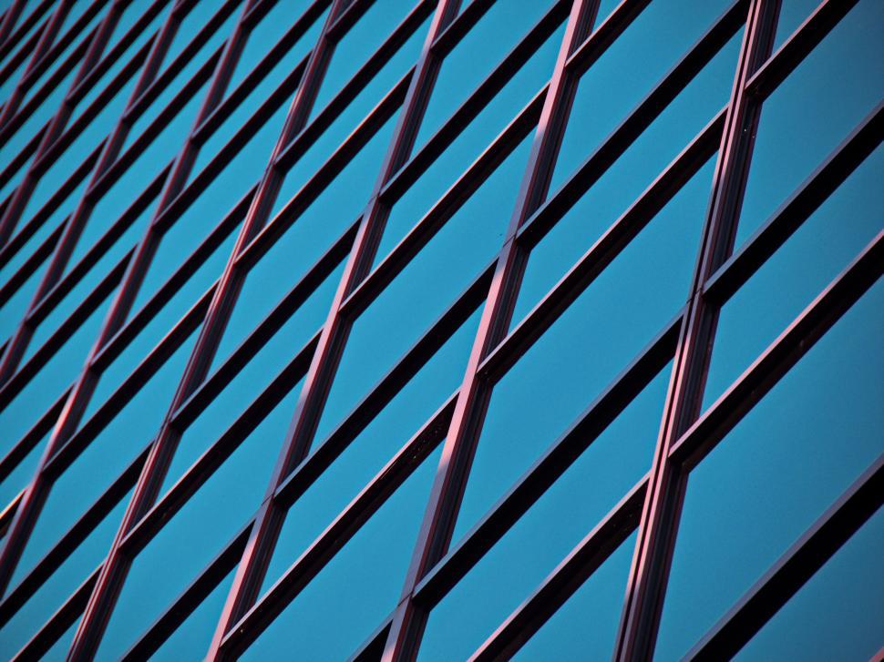 Free Image of Blue building reflective glass with geometric grid design 