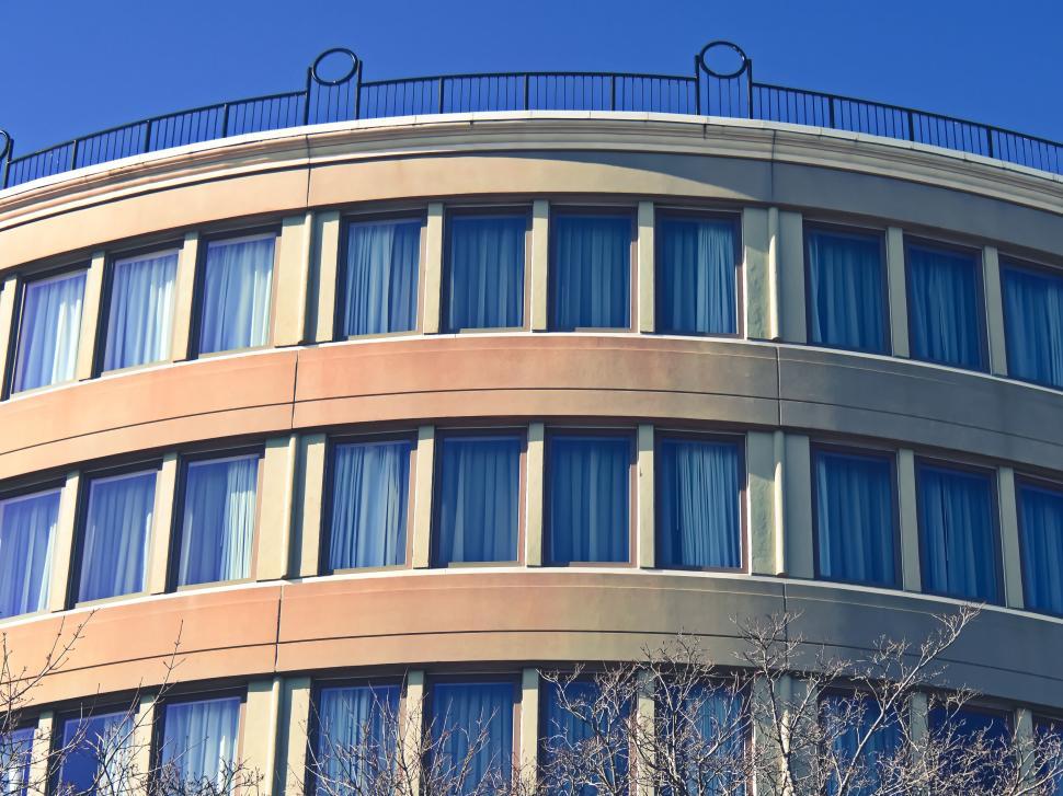 Free Image of Rounded modern building facade with many windows. 