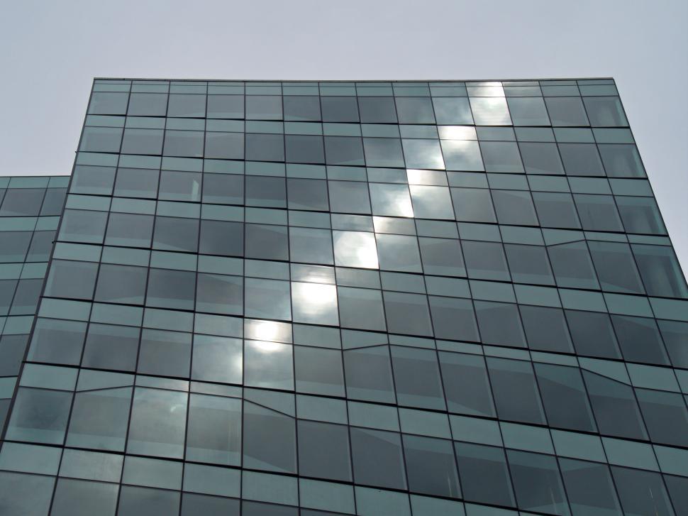 Free Image of Curved modern glass skyscraper reflecting sunlight rays 