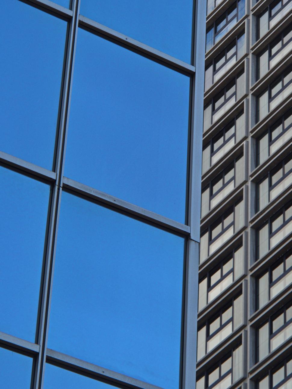 Free Image of Urban reflections in modern glass skyscraper exterior 