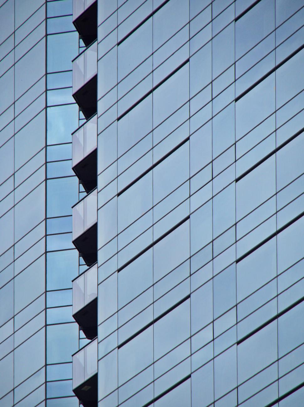 Free Image of Modern glass facade with vertical balconies design 
