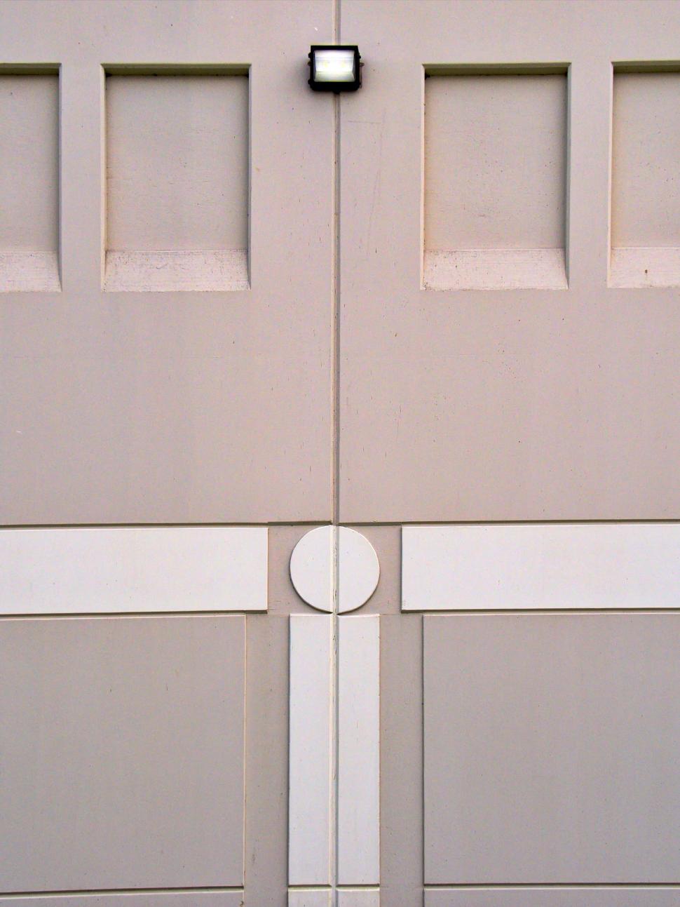 Free Image of Symmetrical garage door with a central white square light. 