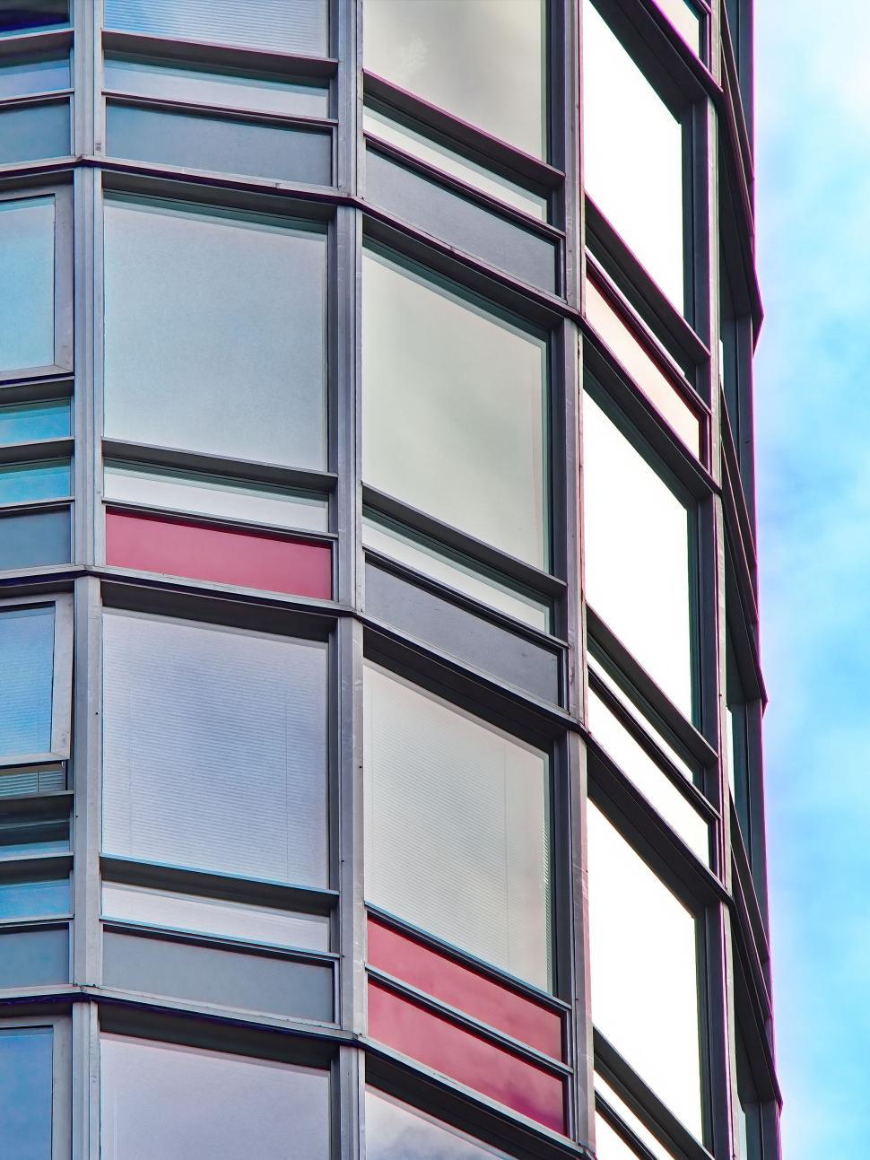 Free Image of Curved Glass Building Facade With Color Accents 