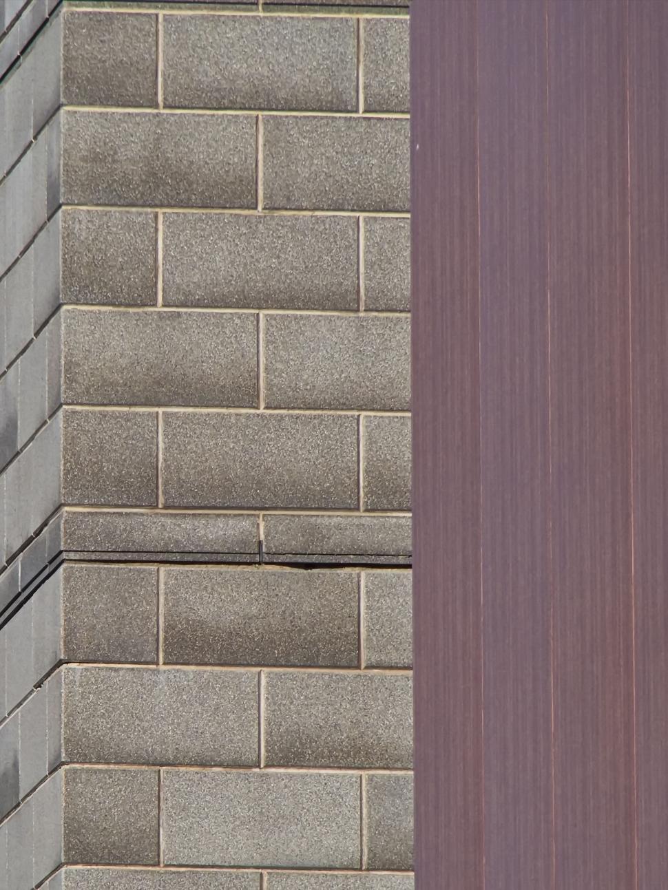 Free Image of Close-up of building exterior showing brick and paneling 