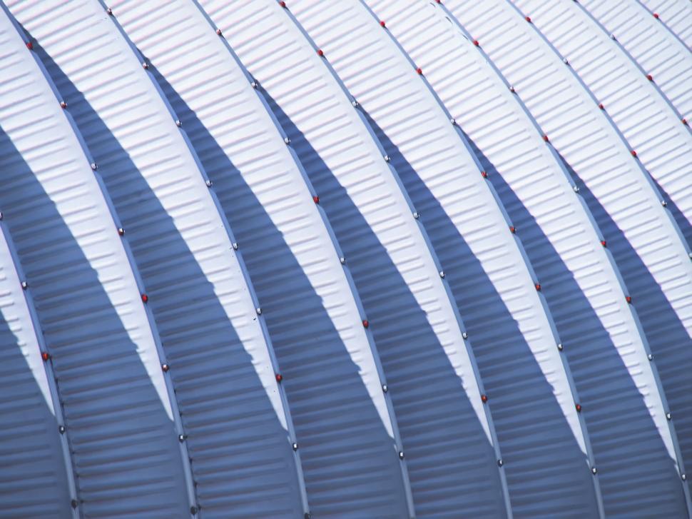 Free Image of Curved metallic roof with distinctive shadows and textures 