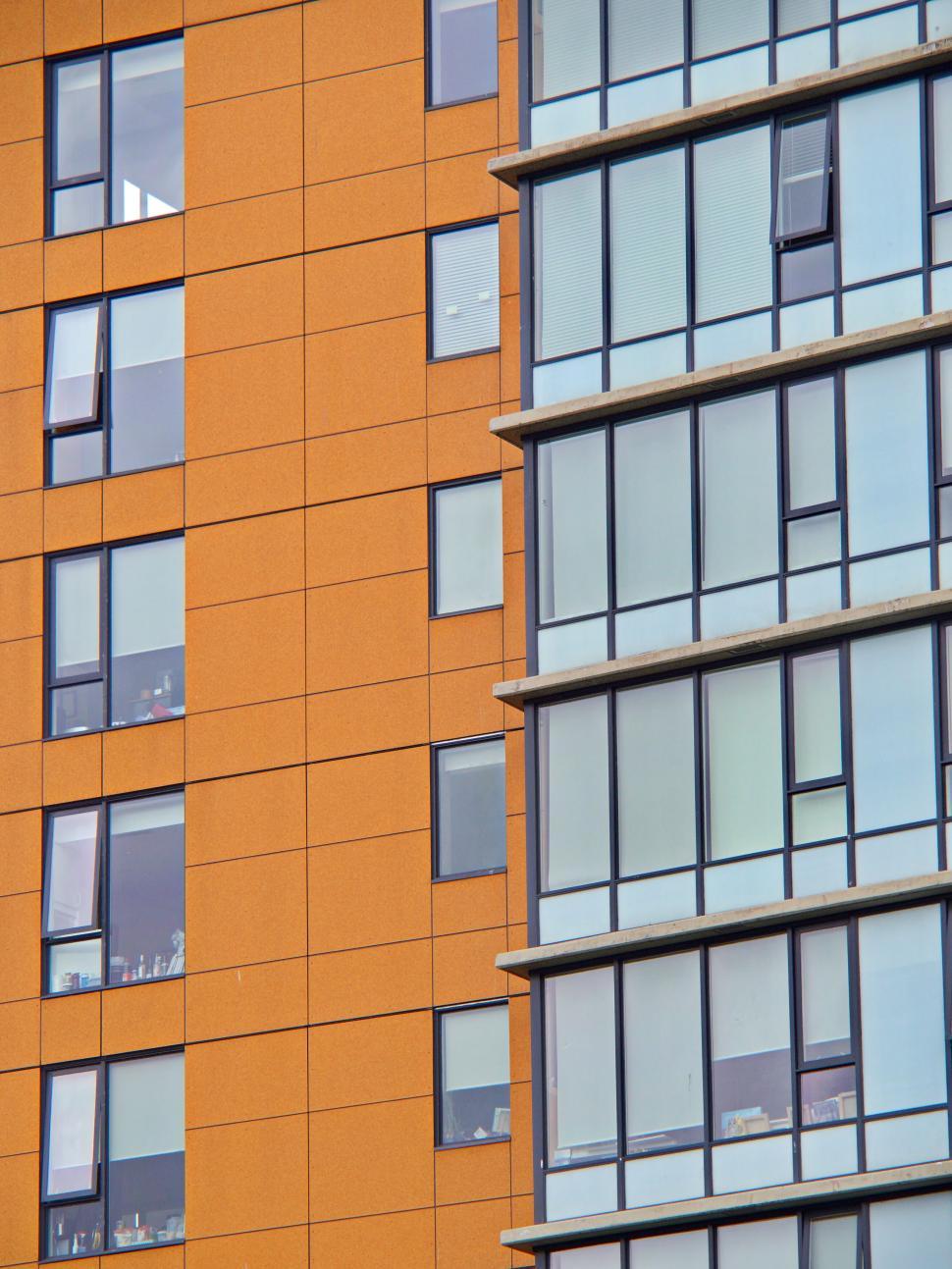 Free Image of Contrasting colored windows on a modern building facade 
