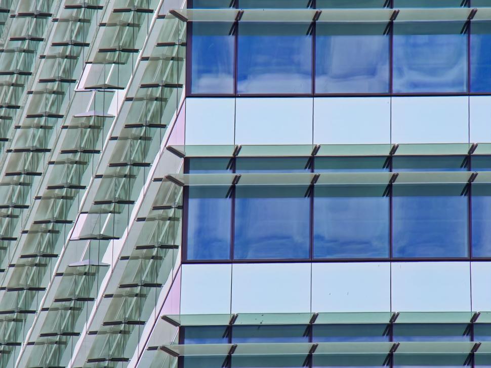 Free Image of Modern glass building with reflections, close-up view. 