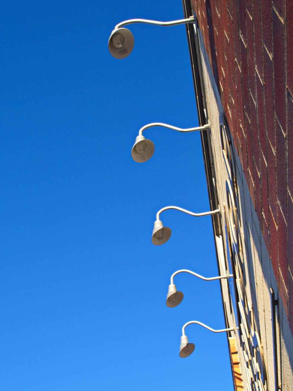 Free Image of Exterior wall of modern building with row of lamps 