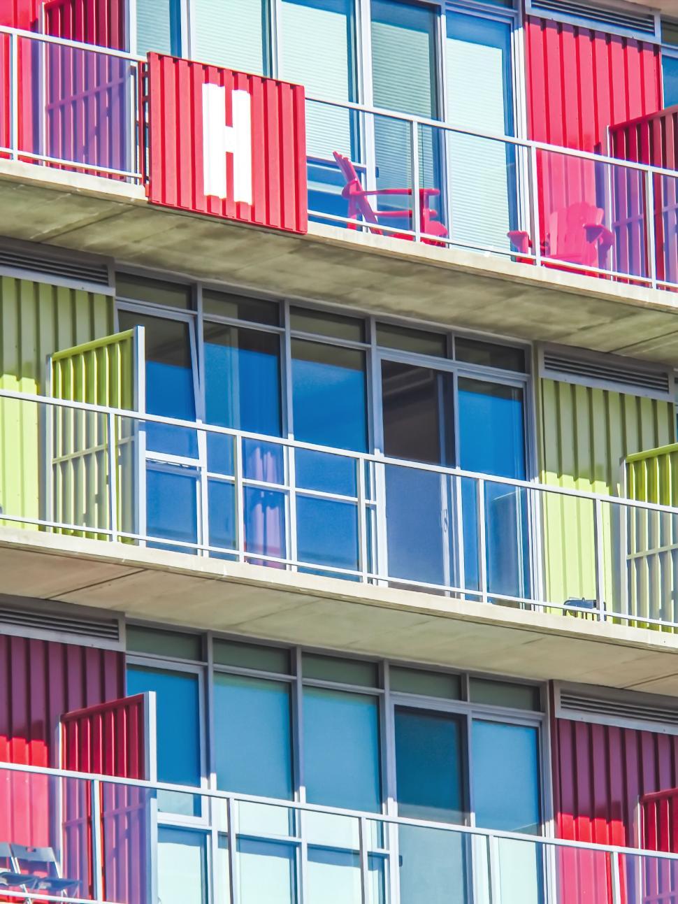 Free Image of Colorful, vibrant apartment building with red and green panels. 