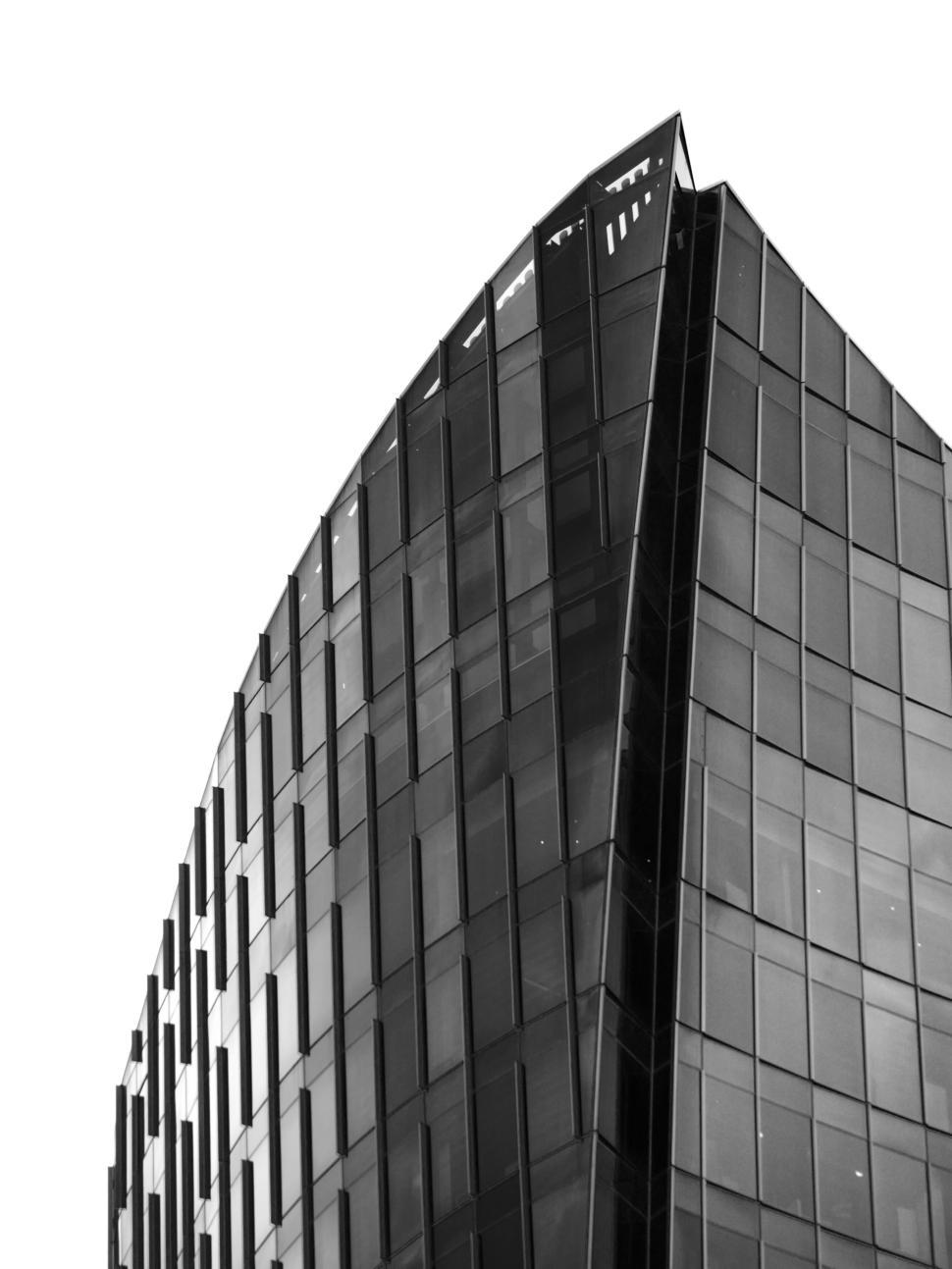 Free Image of Black and white photo of a sleek modern glass building 