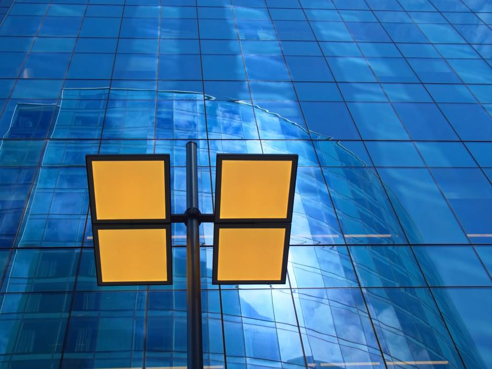 Free Image of Exterior view of modern glass skyscraper with lamps. 
