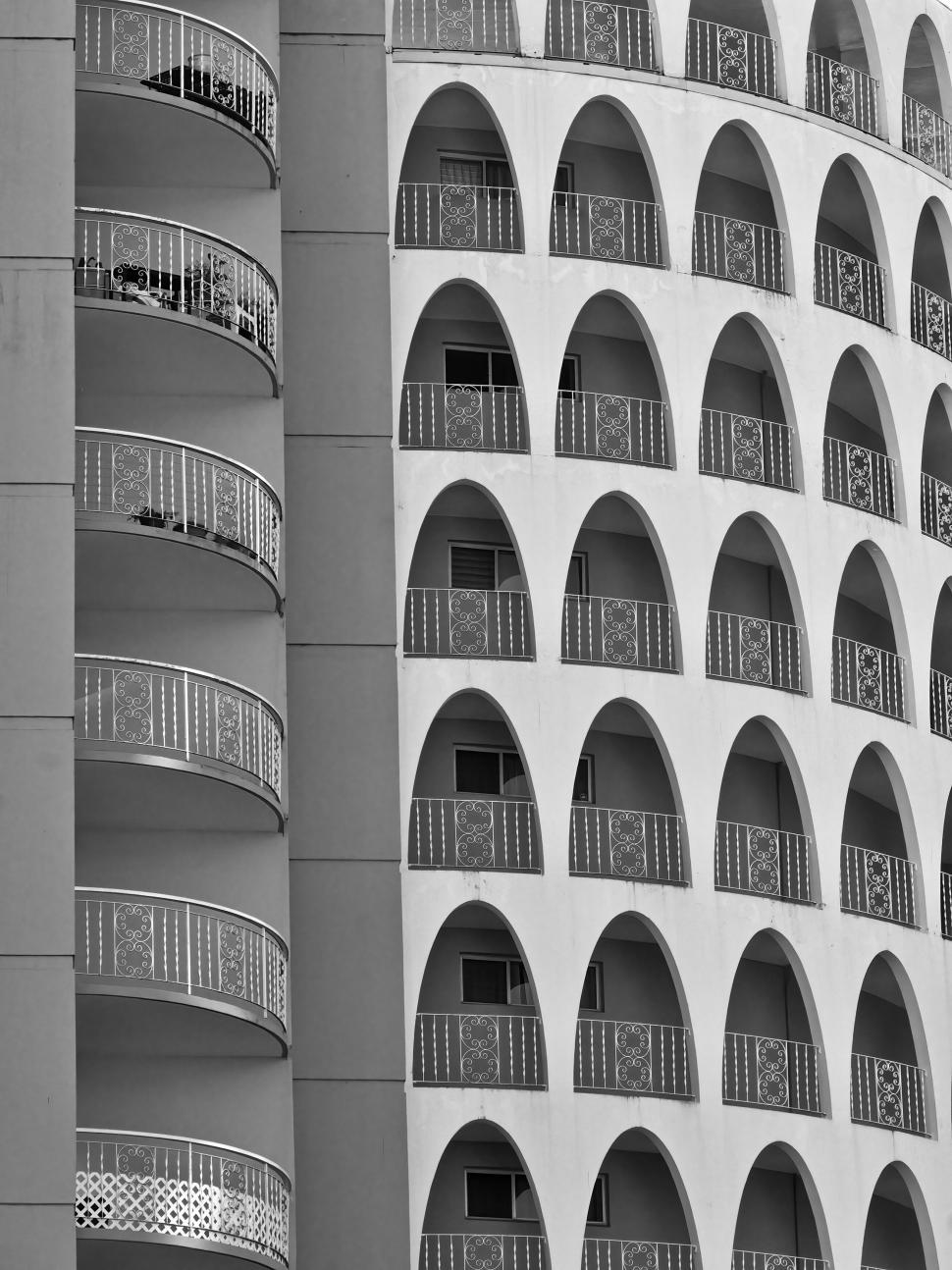Free Image of Black and white photo of arched balconies on building. 