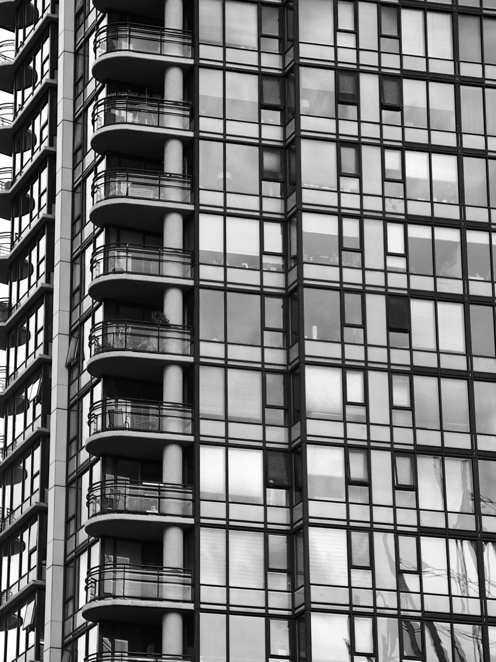 Free Image of Black and white skyscraper with reflective glass windows 