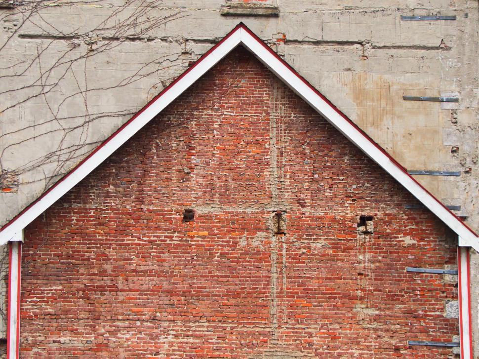 Free Image of Red brick wall with geometric roof line detail view 