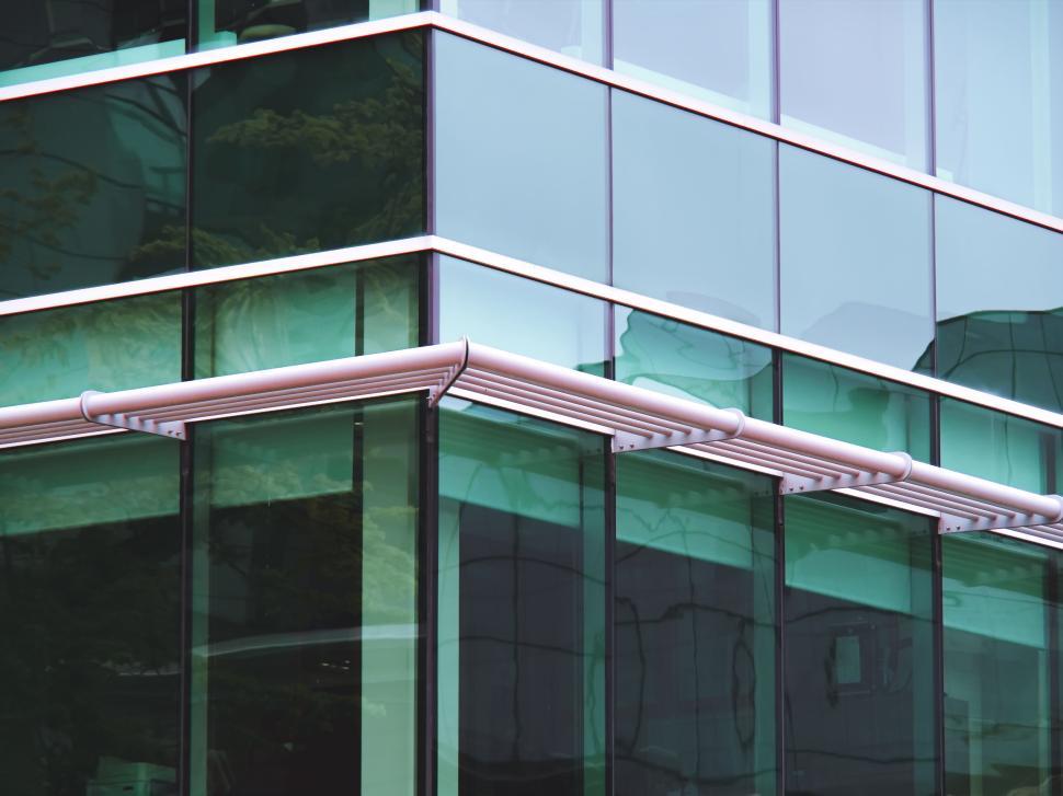 Free Image of Green glass façade of a contemporary office structure. 